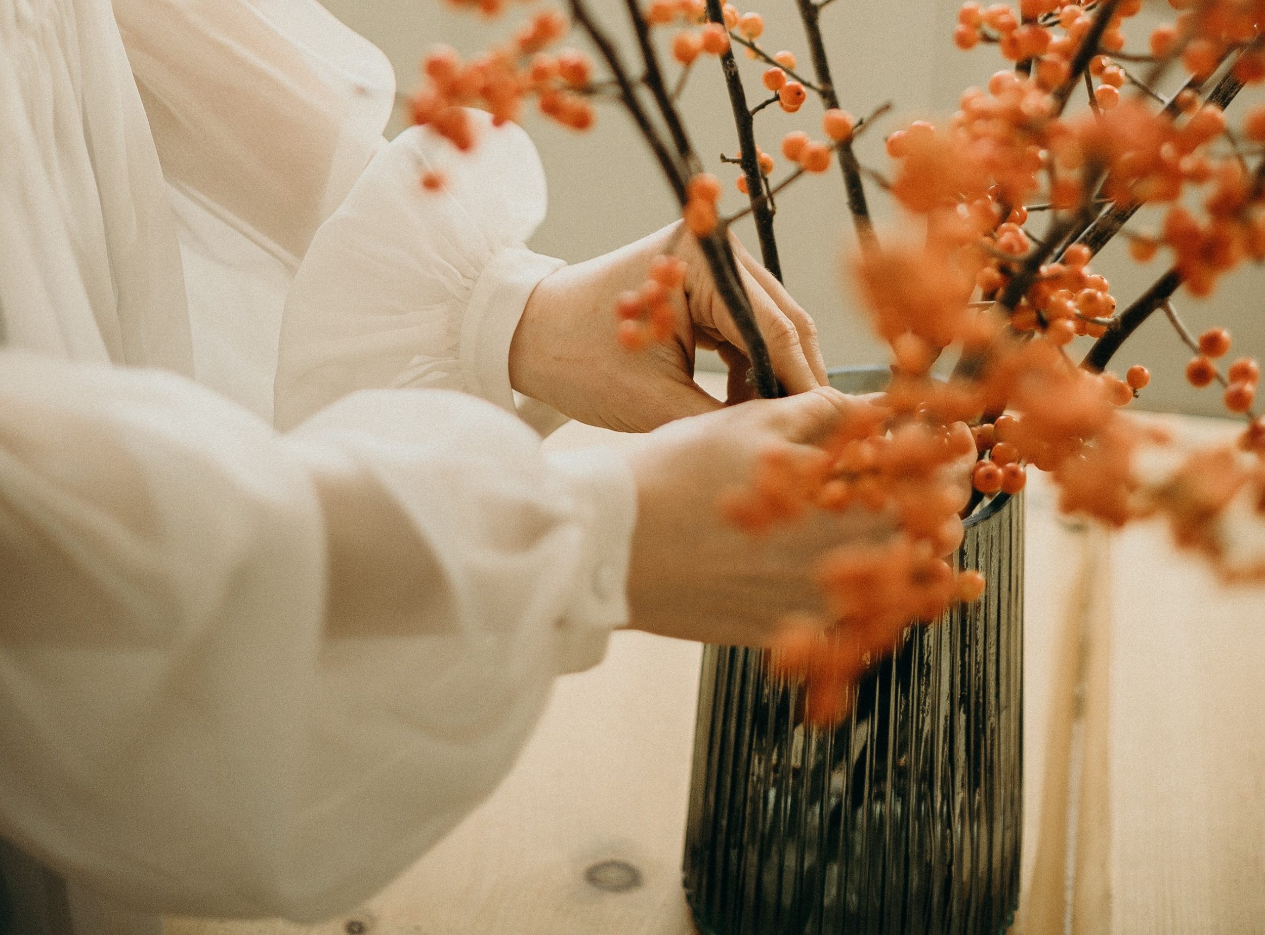Woman arranging dried floral branches