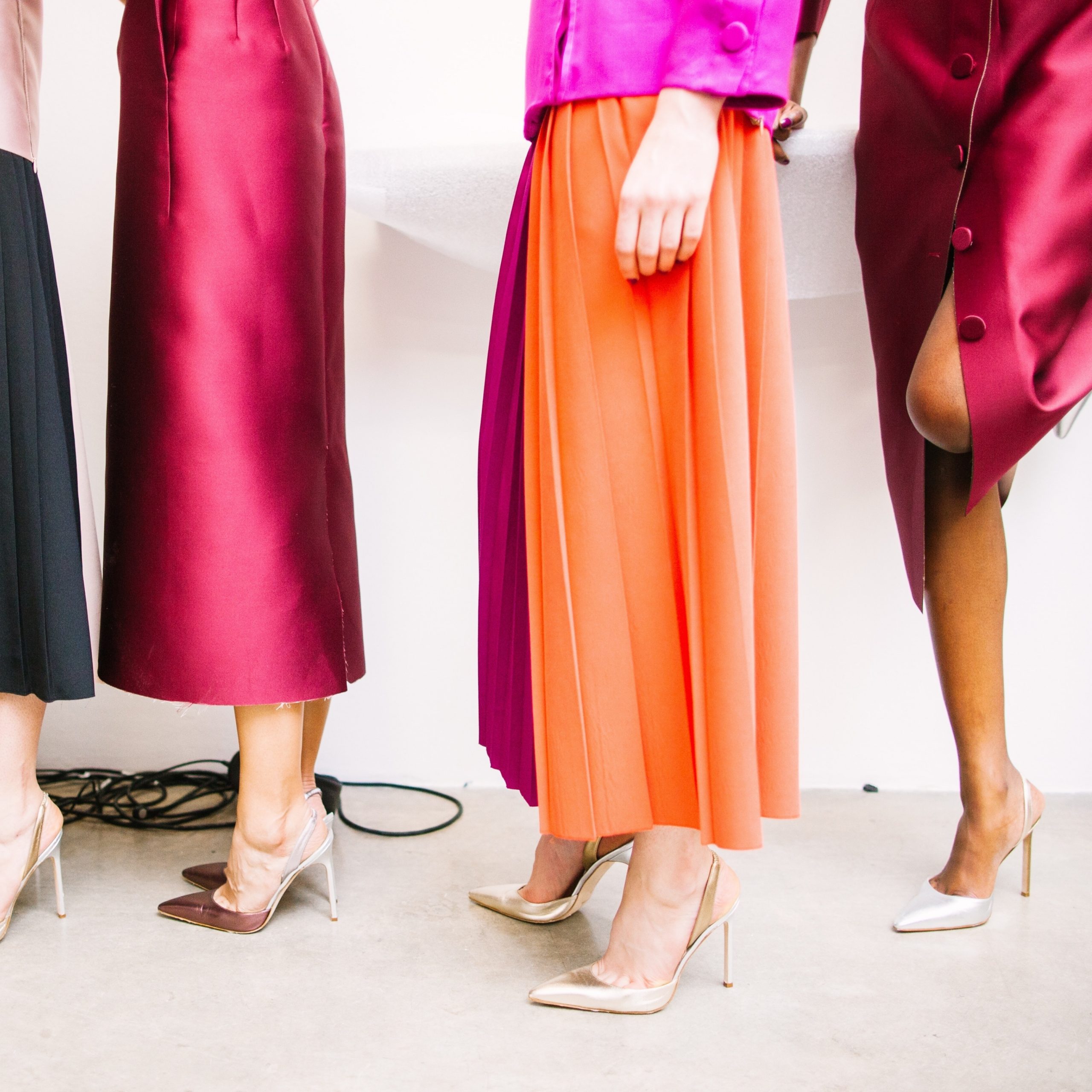 Women standing in line with colourful outfits