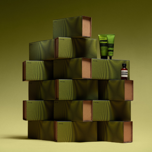a stack of boxes with a lotion and a bottle on top