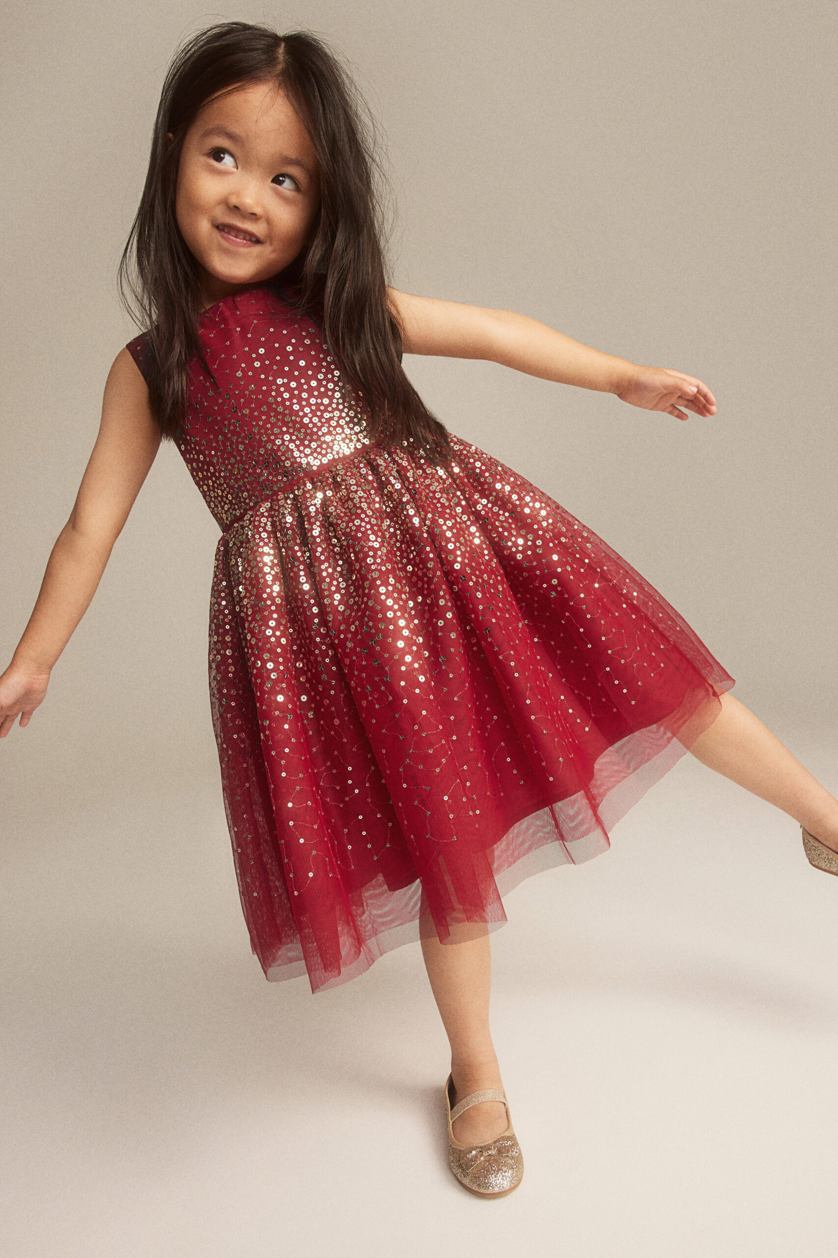 Little girl wearing a sparkly red dress
