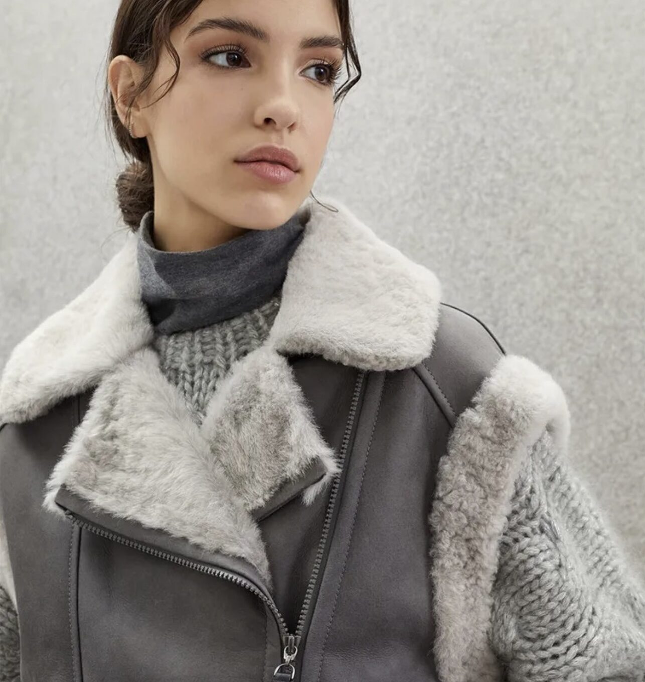 Woman wearing a grey shearling coat