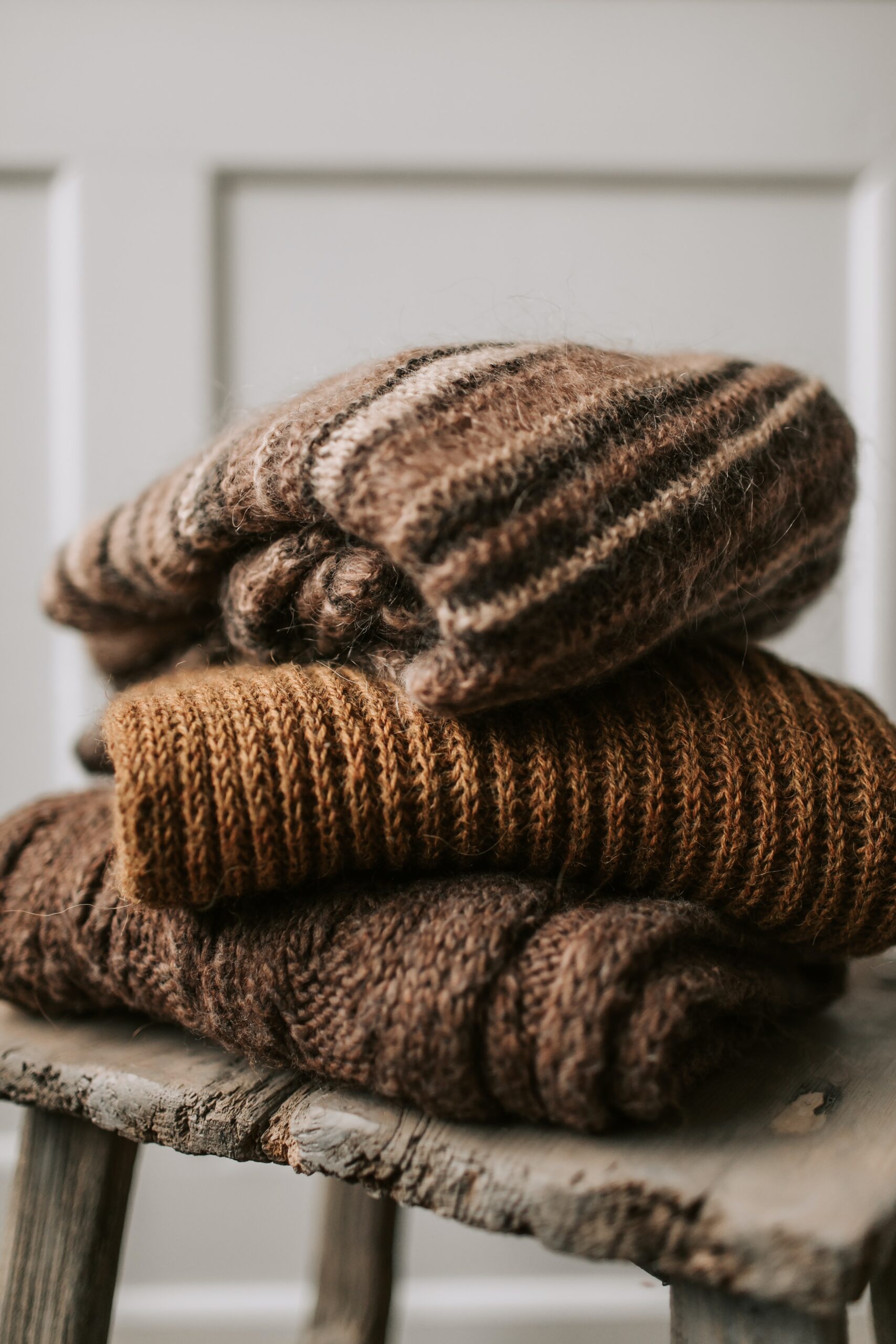 Three folded brown throw blankets