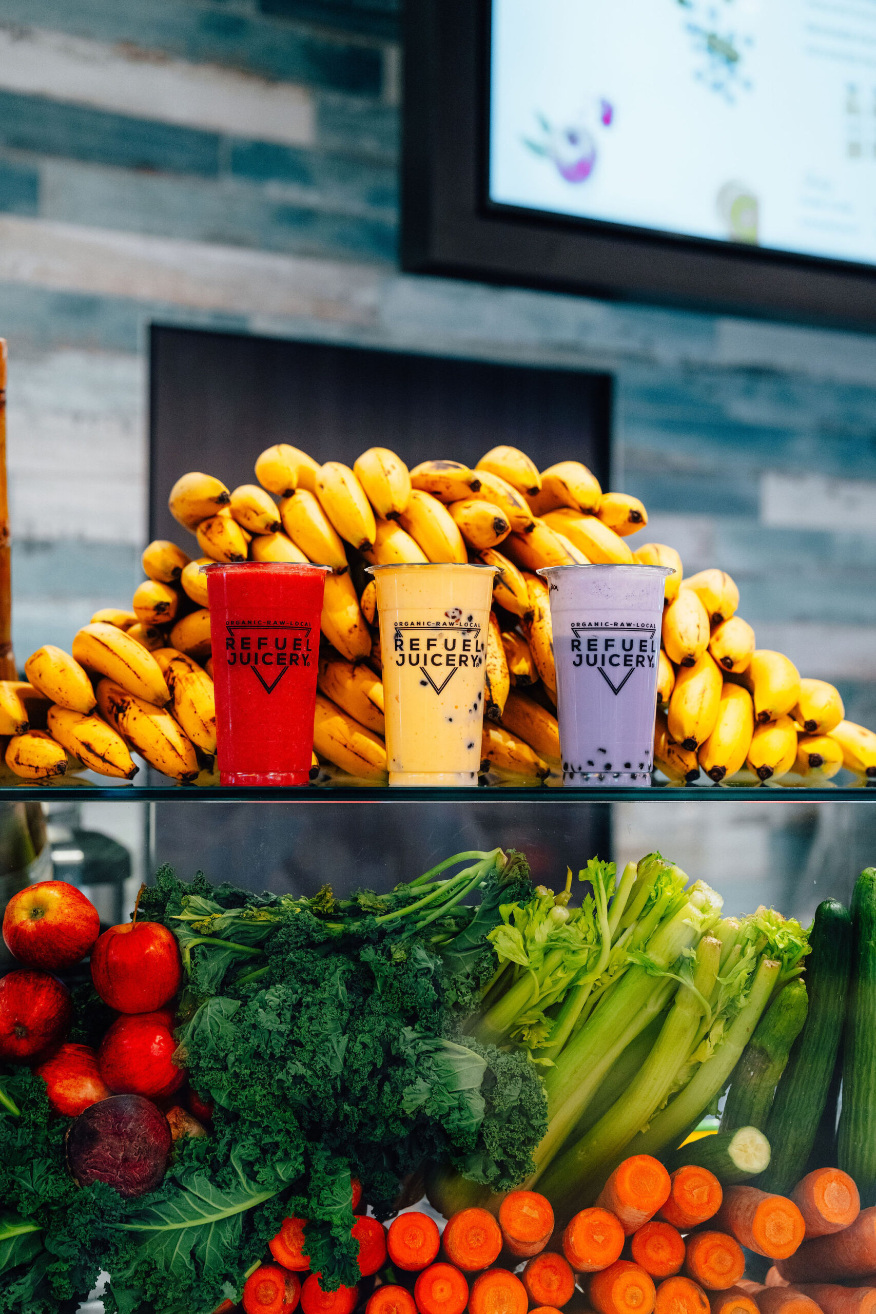 Three fruit smoothies placed on a counter