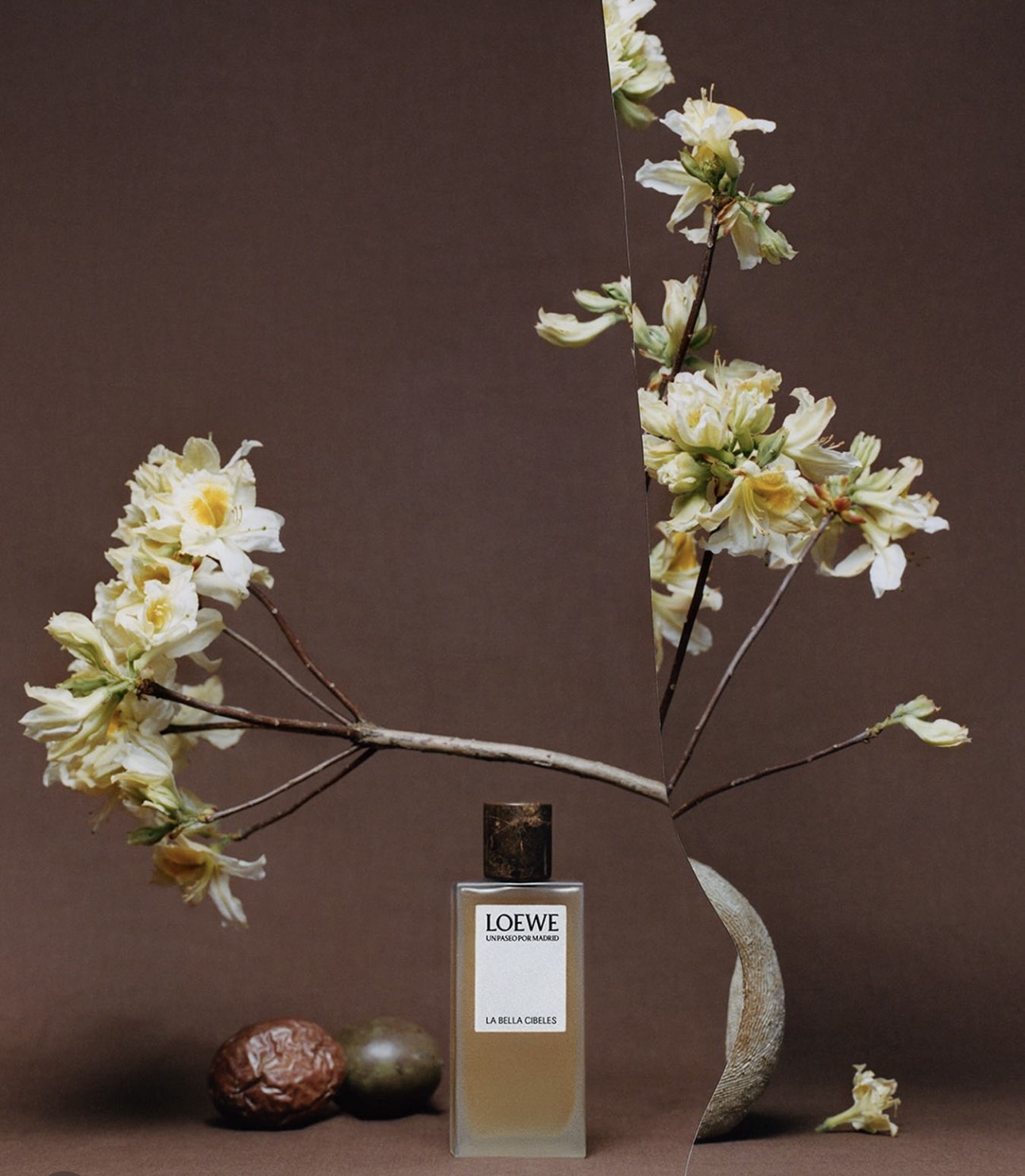 A bottle of perfume and flowers