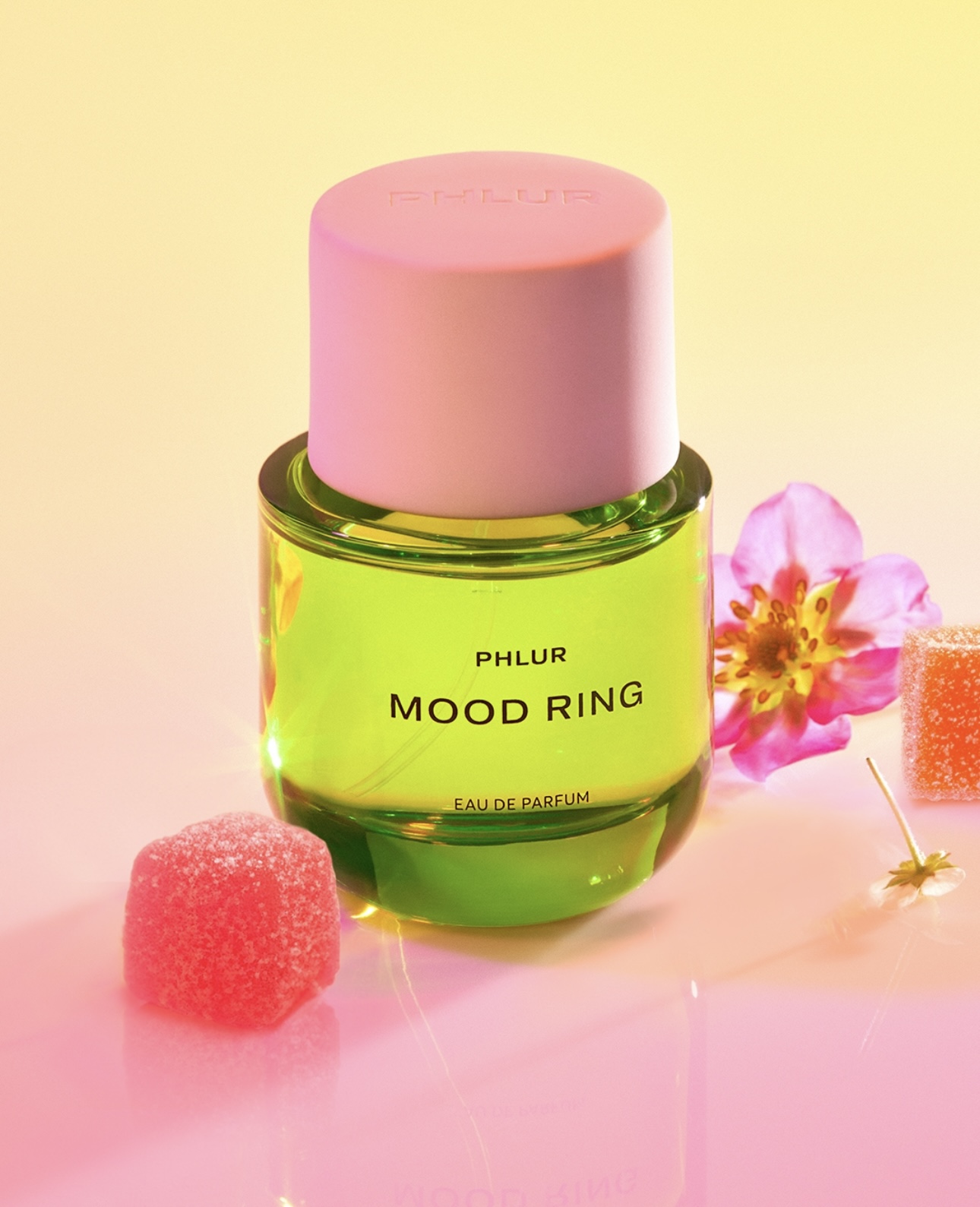 A bottle of perfume and a flower