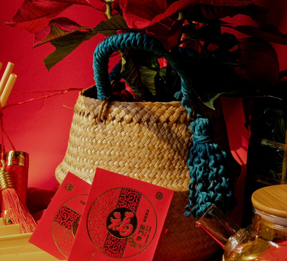 red envelopes in front of a baskset and red flower