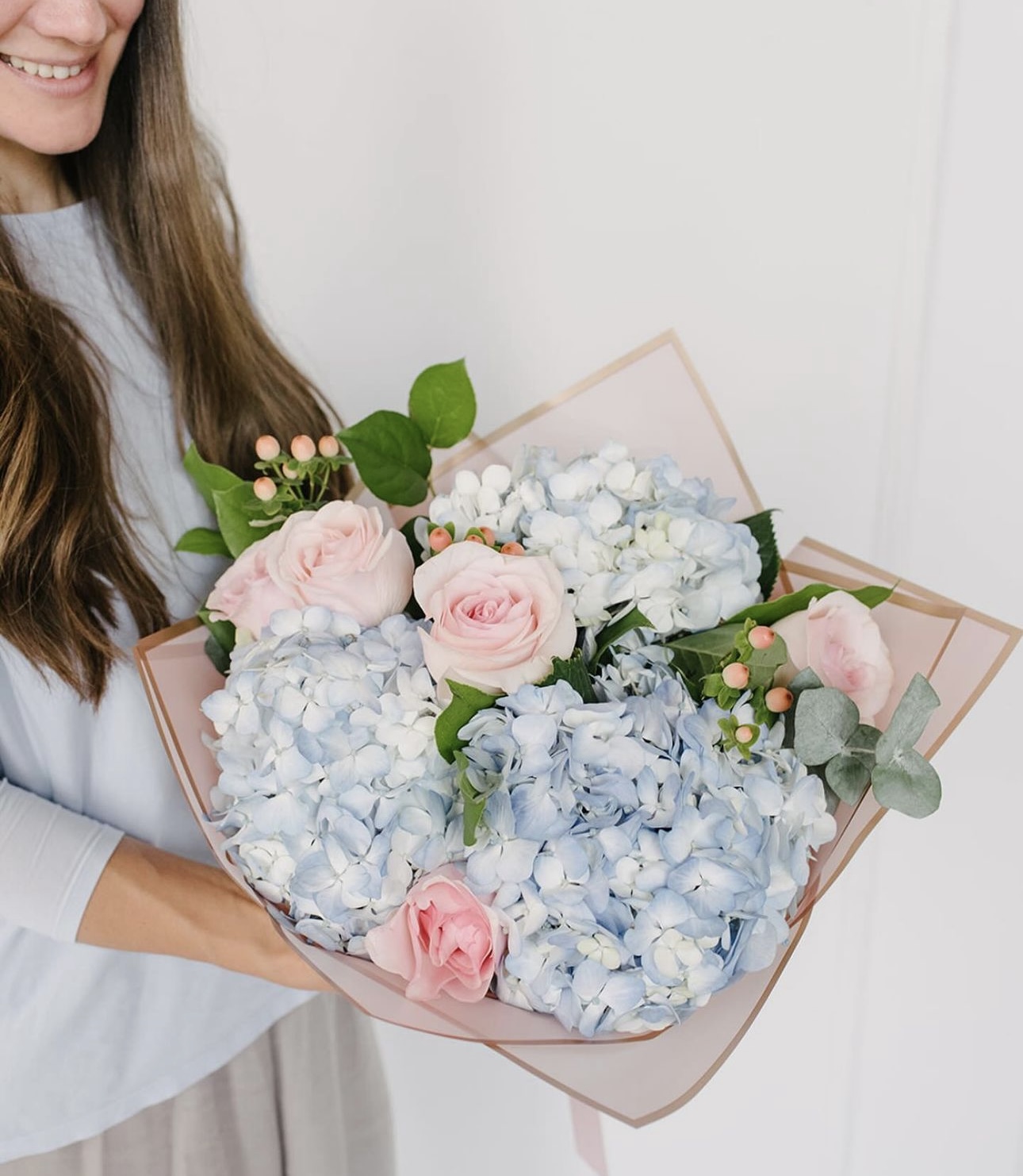 A woman holding a bouquet of flowers