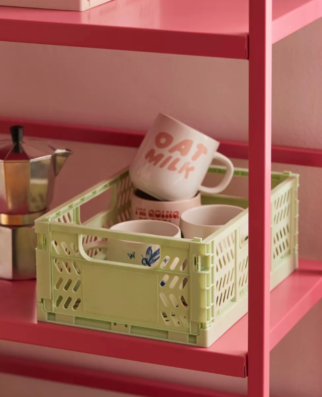 A crate sitting on a shelf that's holding a mug