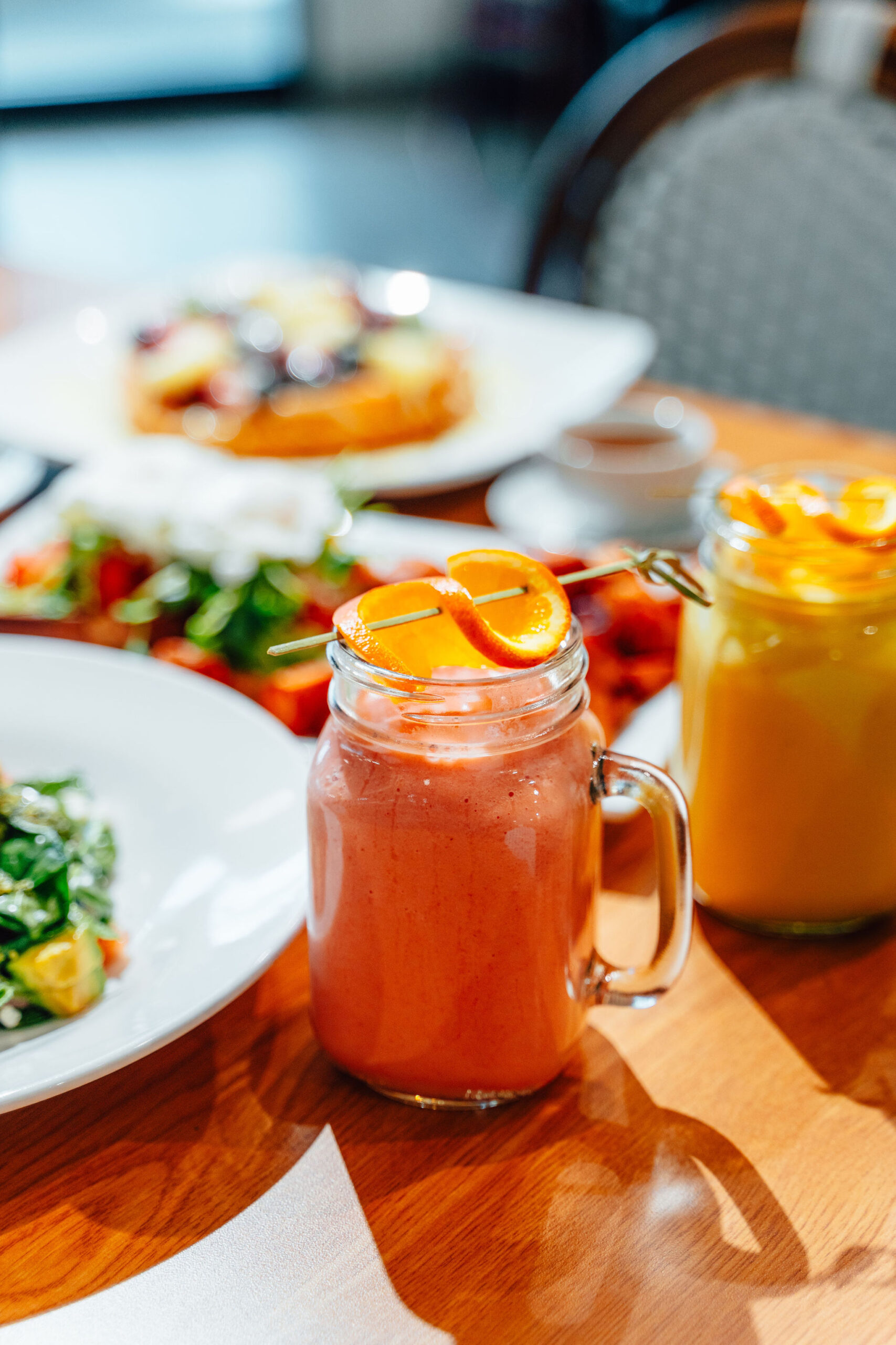 A fruit juice and breakfast dishes.