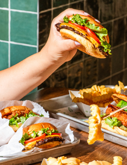 Someone holding a Shake Shack burger